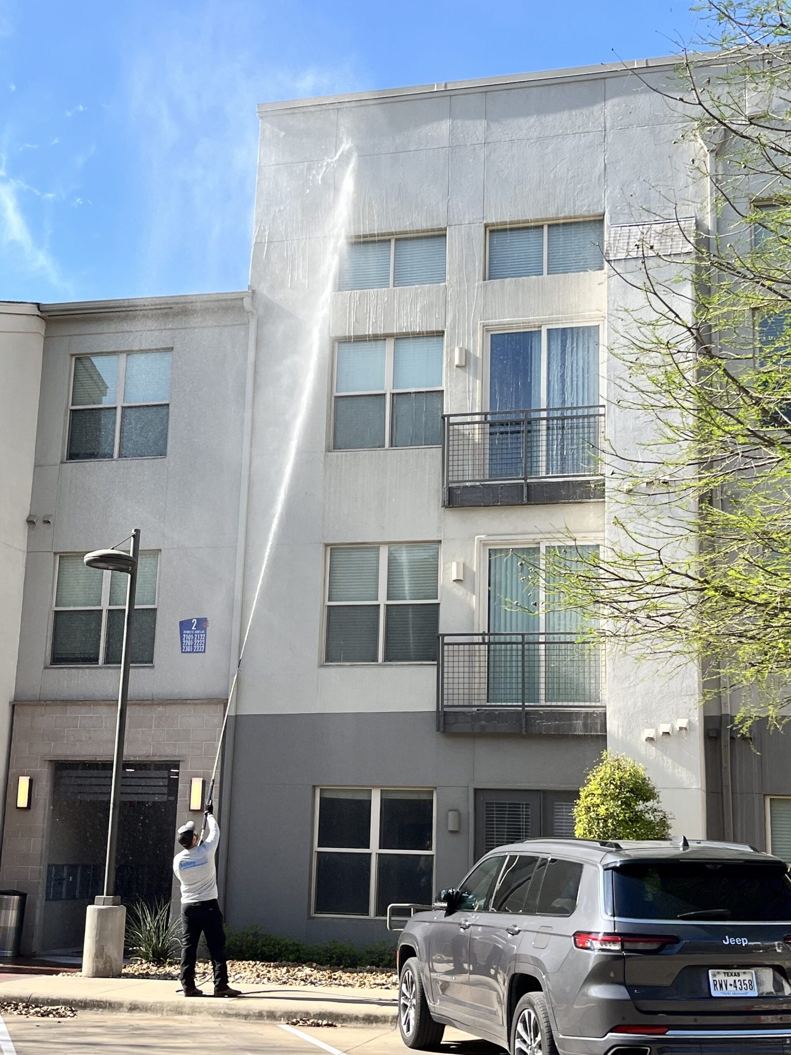 Facade soft washing on a multi-story building